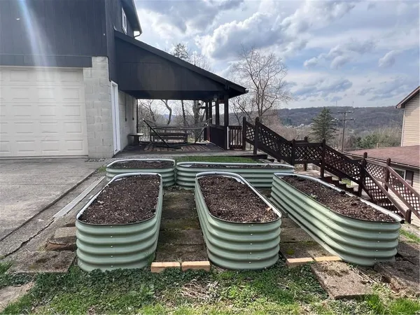a view of a back yard of the house with green space