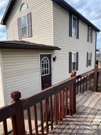 a view of a house with wooden deck
