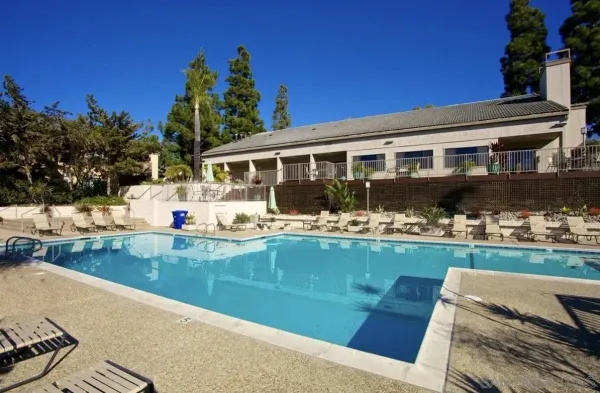 a front view of a house with swimming pool having outdoor seating