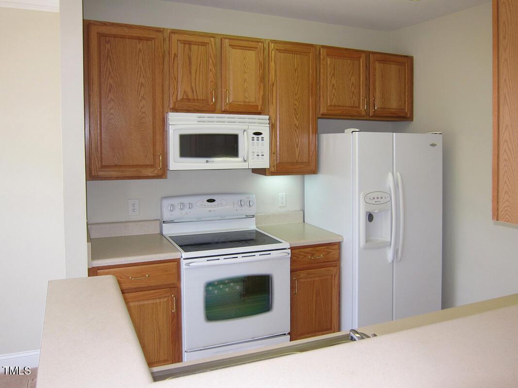 831 Providence Glen Drive Chapel Hill, NC 27514 - Photo 4 of 14 a kitchen with a stove and a microwave