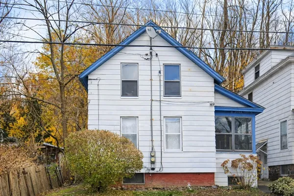 a view of house with a yard