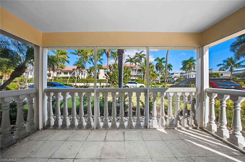 666 3rd Street South, Unit 106 Naples, FL 34102 - Photo 12 of 32 a view of a porch with a floor to ceiling window next to a yard