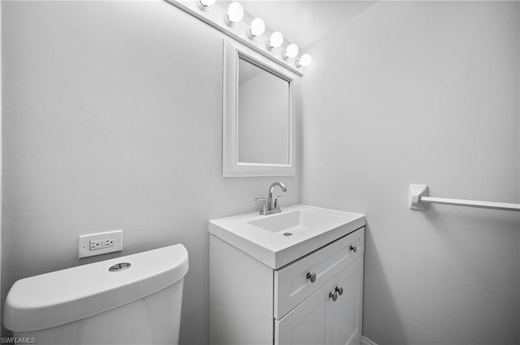 666 3rd Street South, Unit 106 Naples, FL 34102 - Photo 18 of 32 a bathroom with a sink a toilet and a mirror