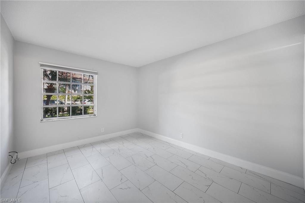 666 3rd Street South, Unit 106 Naples, FL 34102 - Photo 19 of 32 an empty room with windows