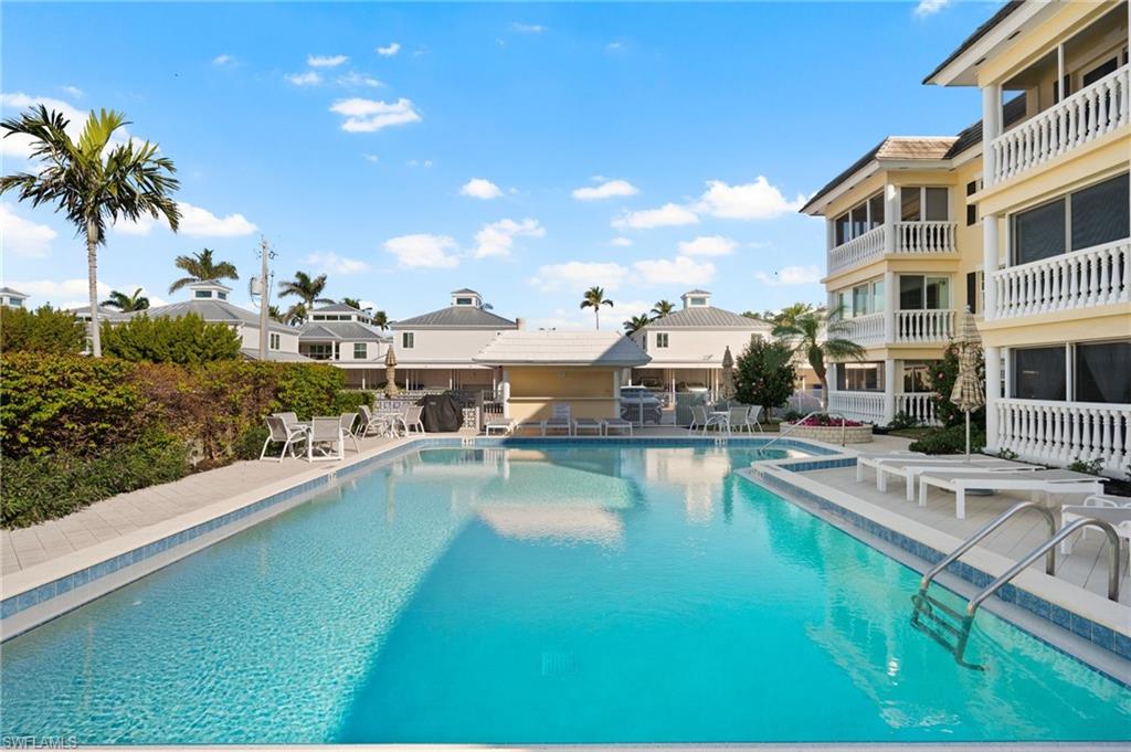 666 3rd Street South, Unit 106 Naples, FL 34102 - Photo 26 of 32 a view of a swimming pool with a patio