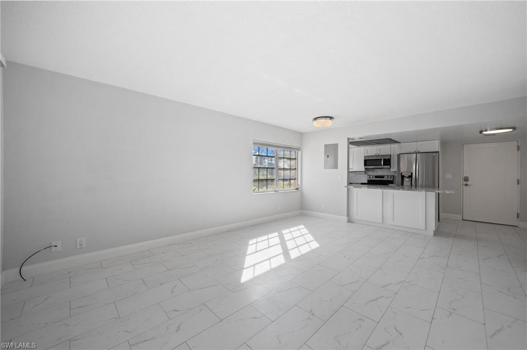 666 3rd Street South, Unit 106 Naples, FL 34102 - Photo 9 of 32 a view of kitchen with windows and refrigerator