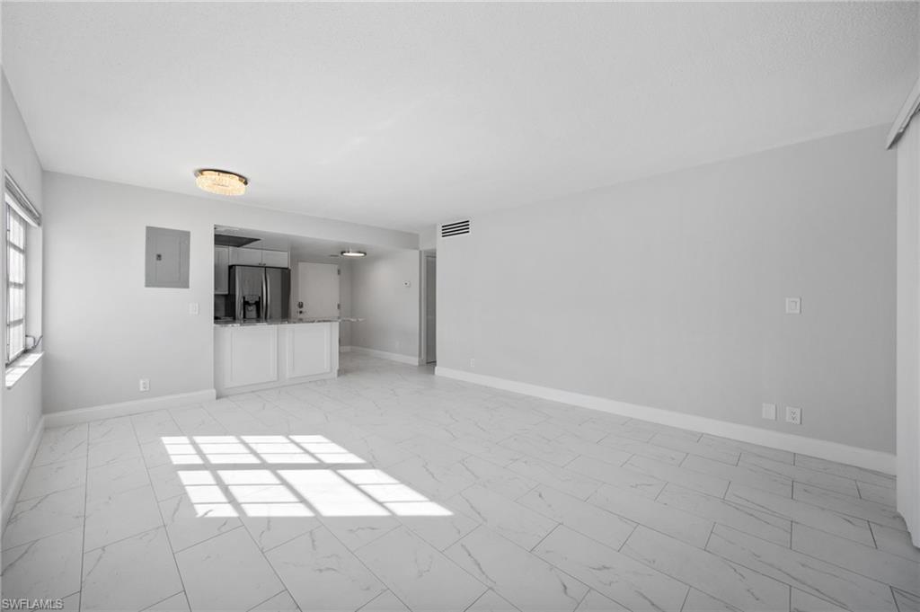 666 3rd Street South, Unit 106 Naples, FL 34102 - Photo 10 of 32 a view of a hallway with closet and white walls