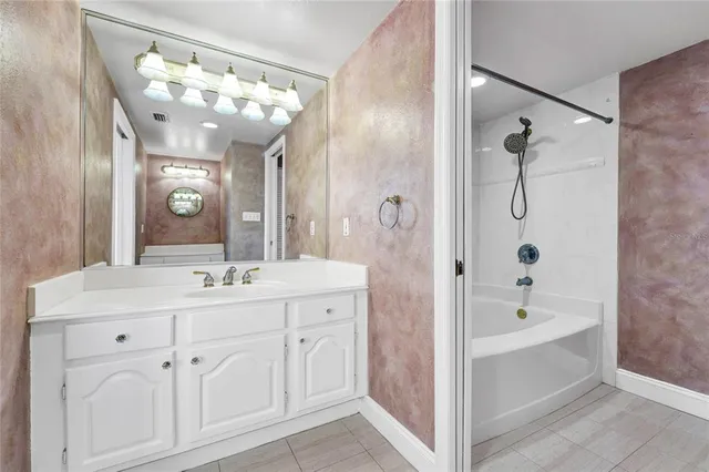 a bathroom with a bath tub with a shower