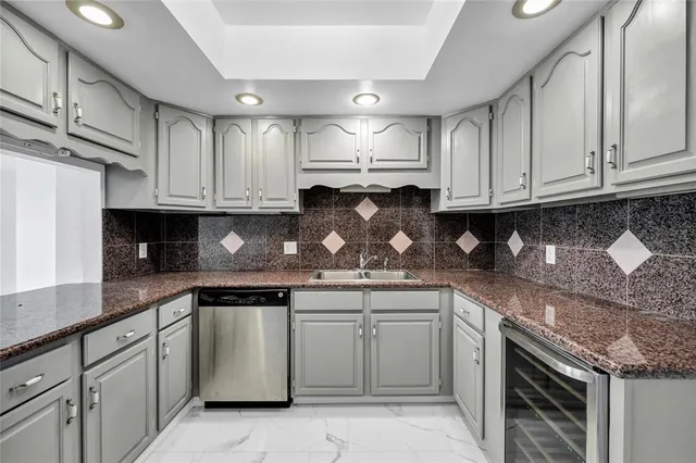 a kitchen with stainless steel appliances granite countertop a refrigerator and a stove top oven