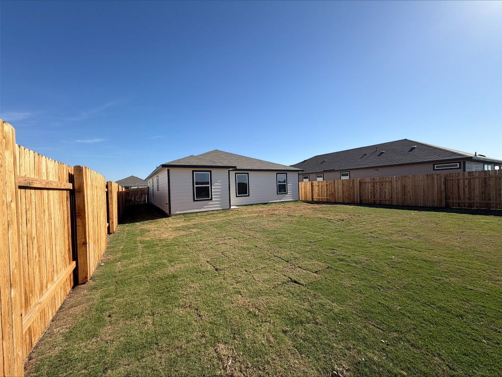 105 Honey Bee Road Jarrell, TX 76537 - Photo 5 of 9 Rear view of house featuring a fenced backyard