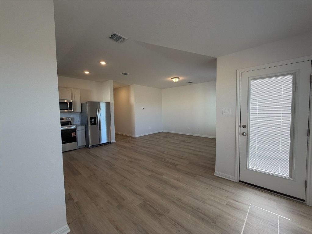 105 Honey Bee Road Jarrell, TX 76537 - Photo 9 of 9 Kitchen with stainless steel appliances, light wood-type flooring, recessed lighting, and light countertops