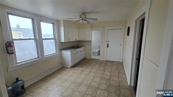 a view of a kitchen with a sink cabinet and a window