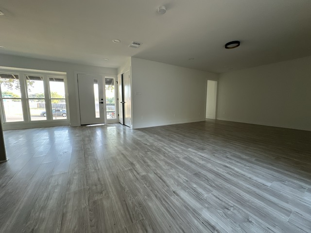2101 Vanderbilt Lane Austin, TX 78723 - Photo 12 of 25 Unfurnished living room with wood finished floors