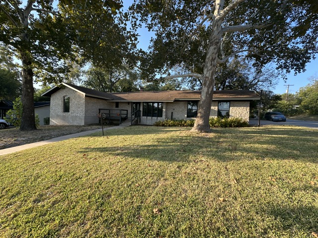 2101 Vanderbilt Lane Austin, TX 78723 - Photo 2 of 25 Ranch-style house with brick siding and a front lawn