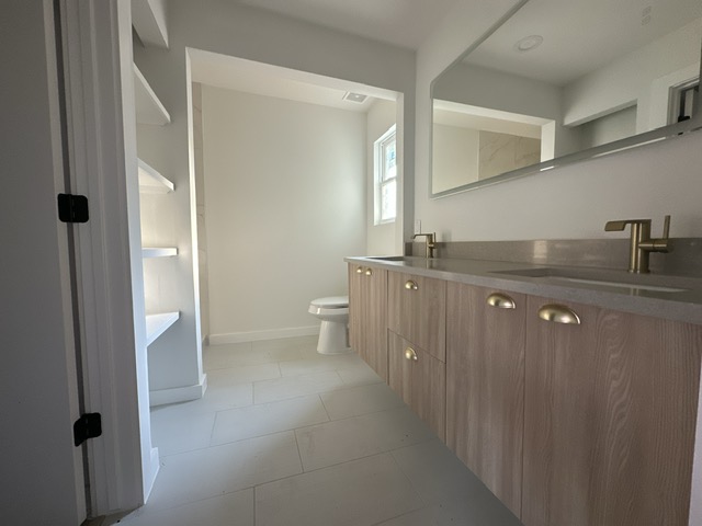 2101 Vanderbilt Lane Austin, TX 78723 - Photo 20 of 25 Bathroom featuring double vanity and light tile patterned flooring