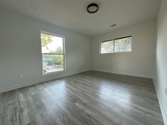 2101 Vanderbilt Lane Austin, TX 78723 - Photo 22 of 25 Spare room with wood finished floors and baseboards
