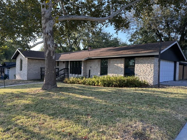 2101 Vanderbilt Lane Austin, TX 78723 - Photo 3 of 25 Ranch-style house with a garage, a front lawn, brick siding, and roof with shingles