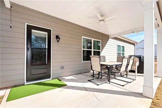 a view of a house with backyard and road