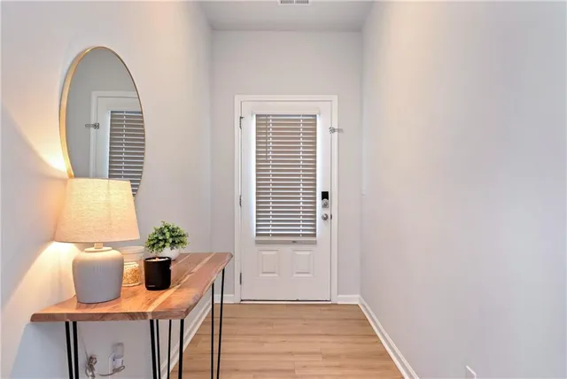a view of a room with wooden floor and furniture