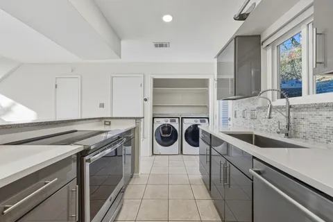 a kitchen with a sink stove and refrigerator
