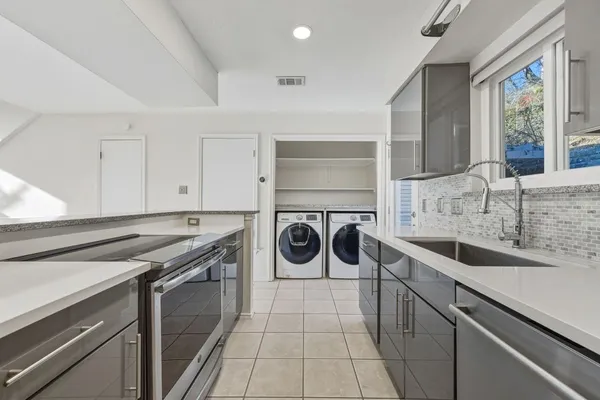 a kitchen with a sink stove and cabinets