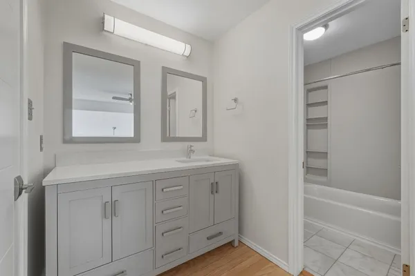 a living room with a bed furniture and a wooden floor