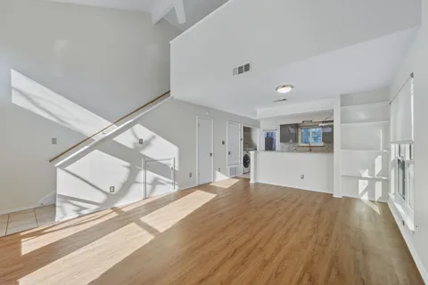 a view of empty room with wooden floor