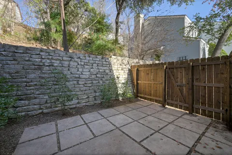 a view of a pathway gate and trees