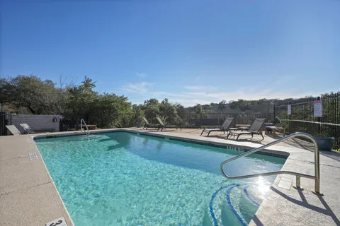 a view of a swimming pool and lounge chairs