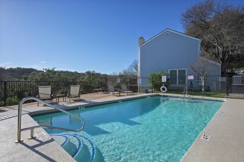 a view of a patio with swimming pool table and chairs