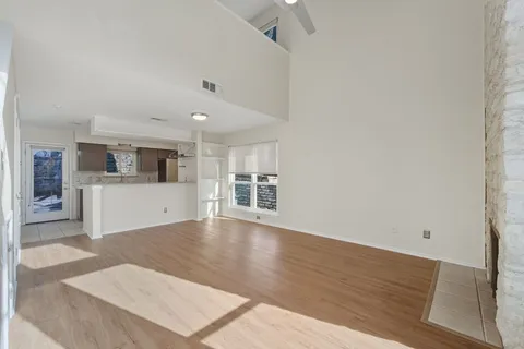 a view of a kitchen with wooden floor and a sink