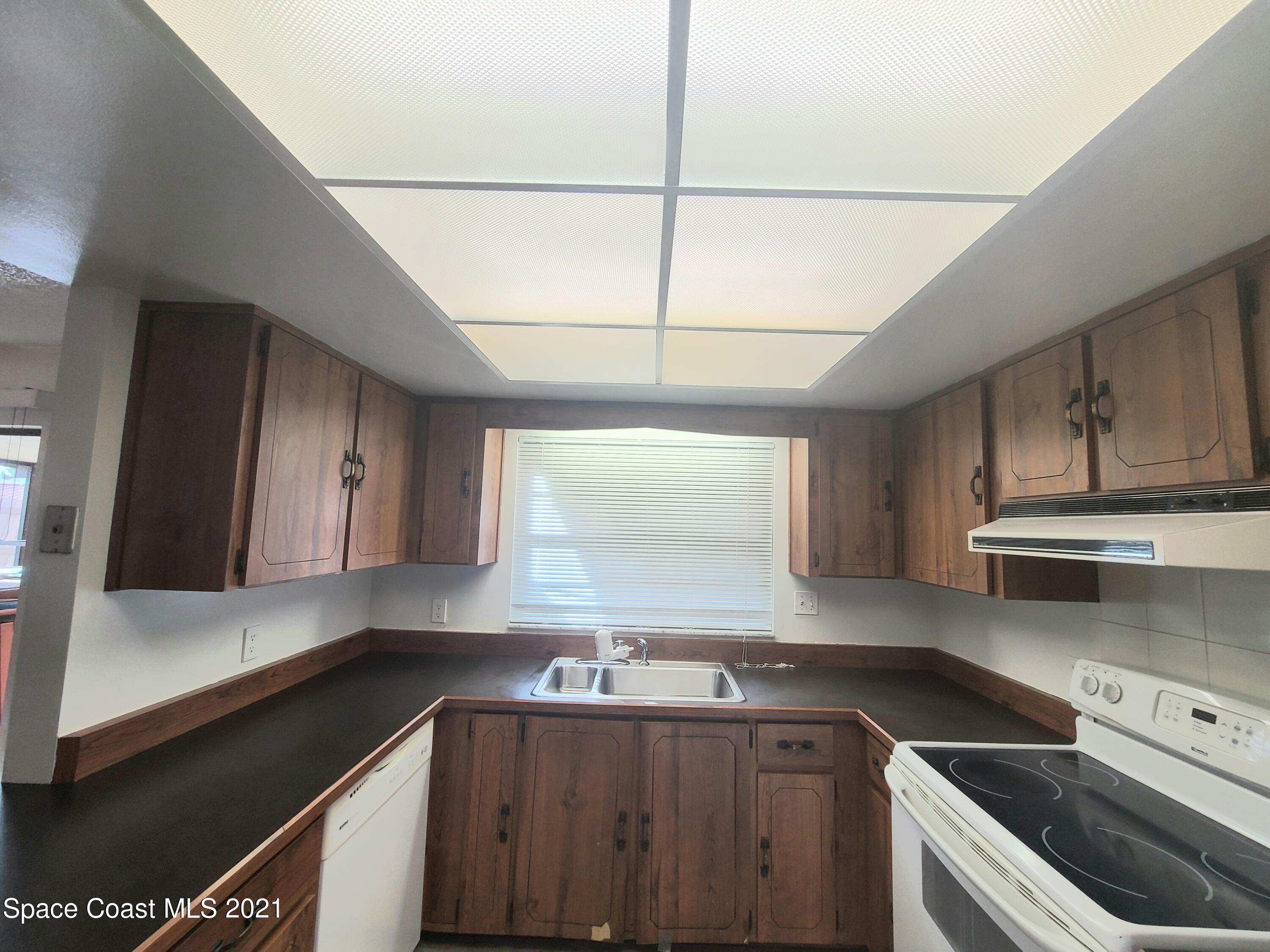 292 Chase Road Cocoa, FL 32927 - Photo 4 of 17 a kitchen with a sink cabinets and window