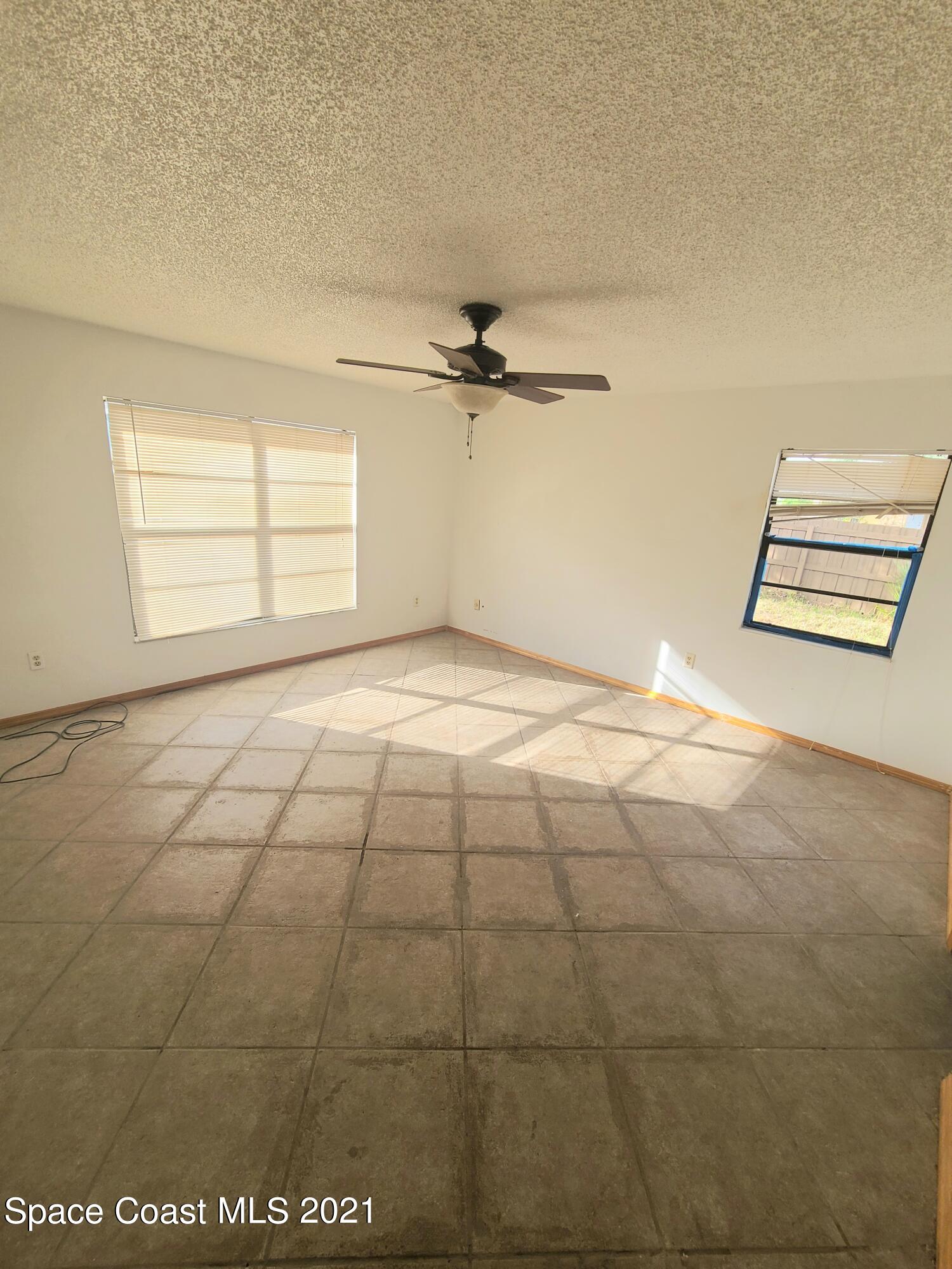 292 Chase Road Cocoa, FL 32927 - Photo 7 of 17 a view of a livingroom with a ceiling fan and window