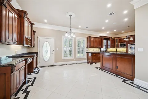 a large kitchen with stainless steel appliances granite countertop a stove and a refrigerator