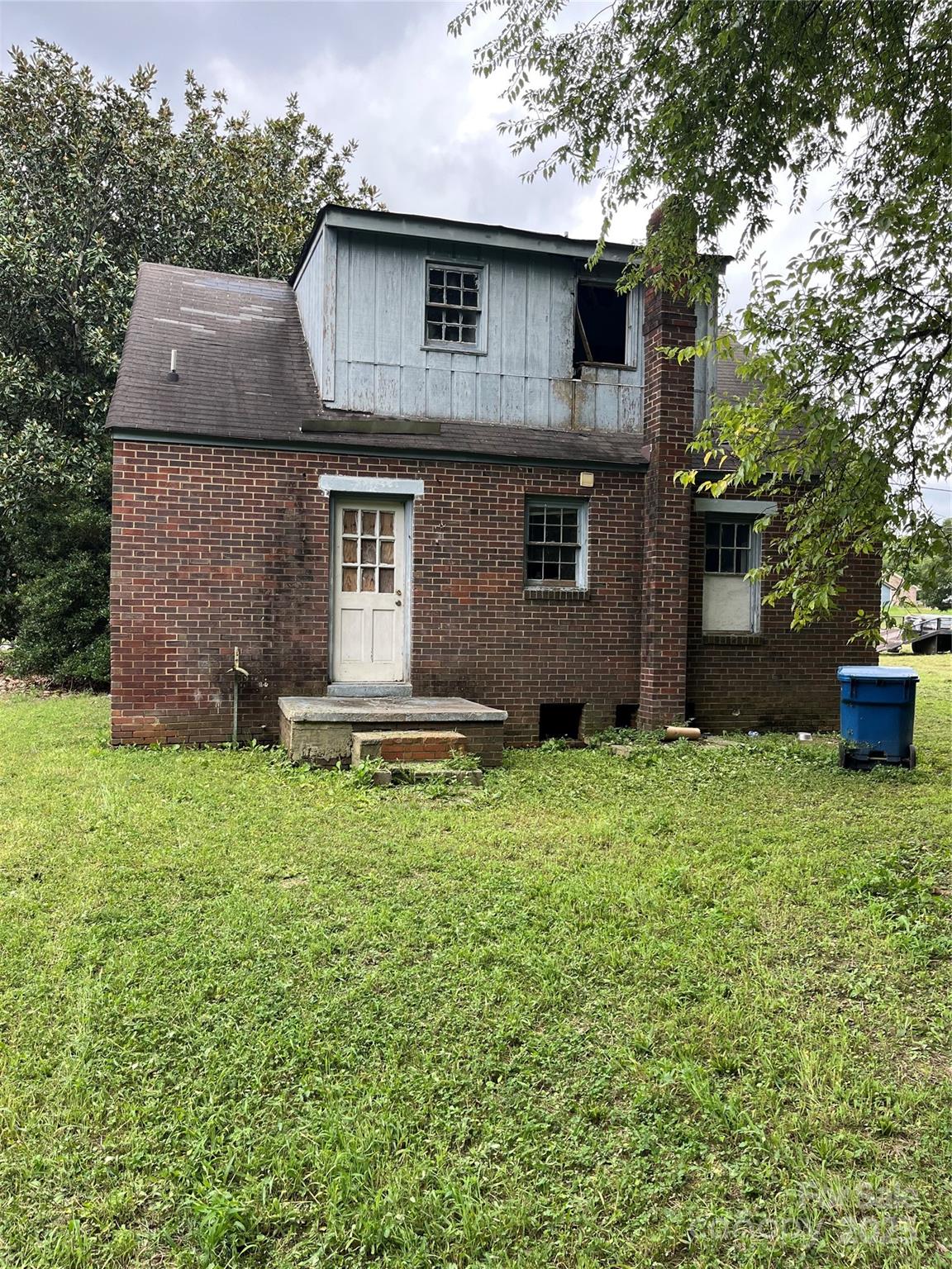 218 South Main Street Wingate, NC 28174 - Photo 3 of 5 a front view of a house with a yard and garage