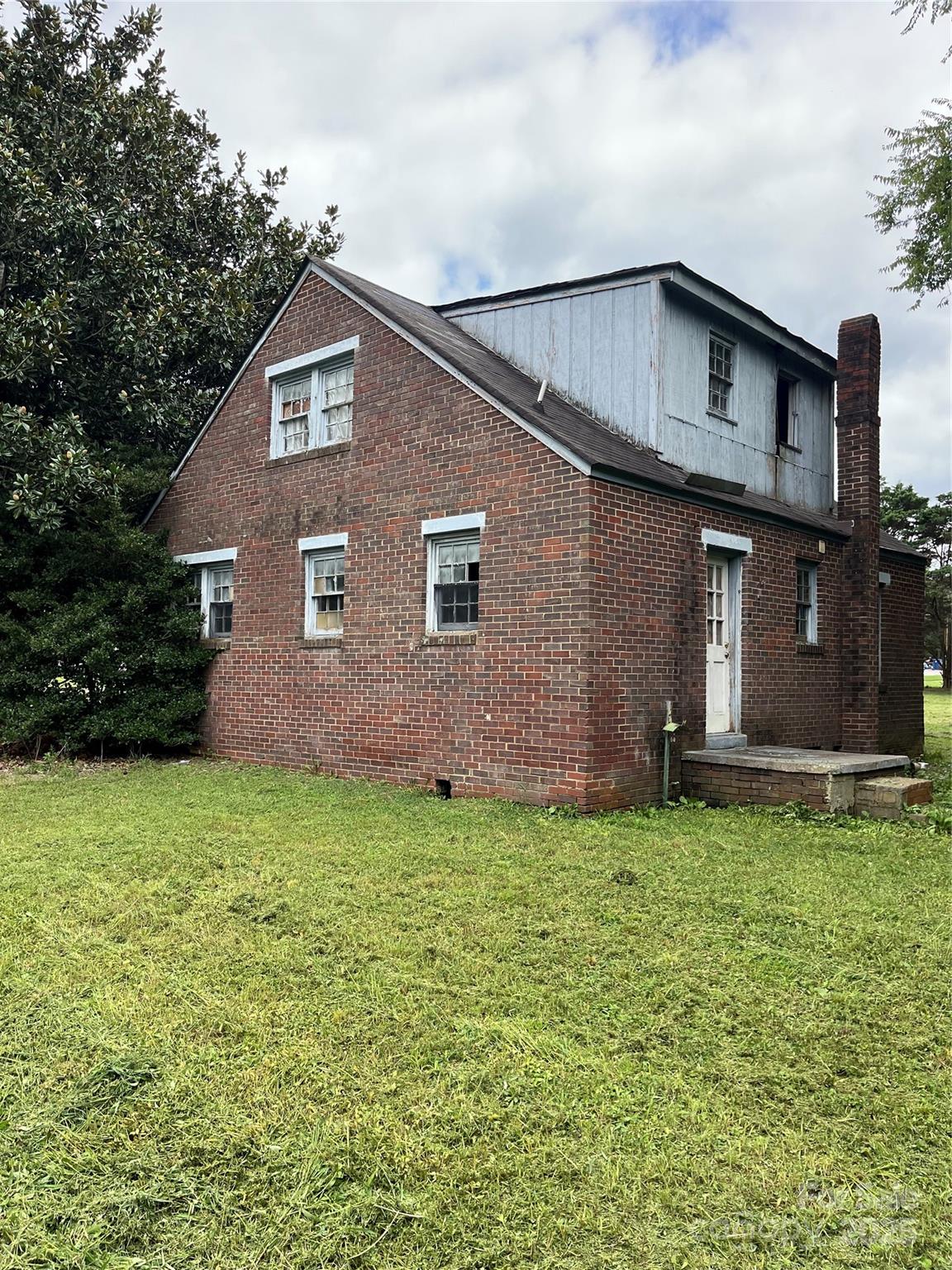 218 South Main Street Wingate, NC 28174 - Photo 4 of 5 a front view of a house with a garden