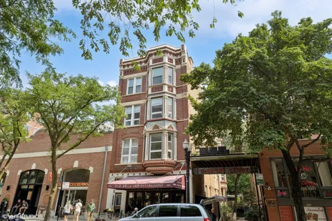 a front view of a building with a garden