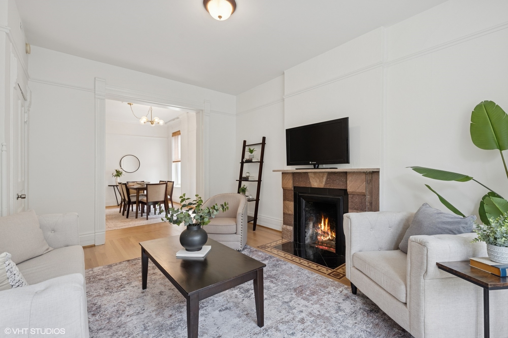 1411 North Wells Street, Unit 3W Chicago, IL 60610 - Photo 11 of 32 a living room with furniture a fireplace and a flat screen tv