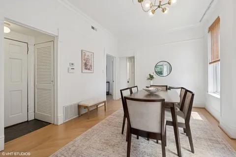 a view of a dining room with furniture and a window