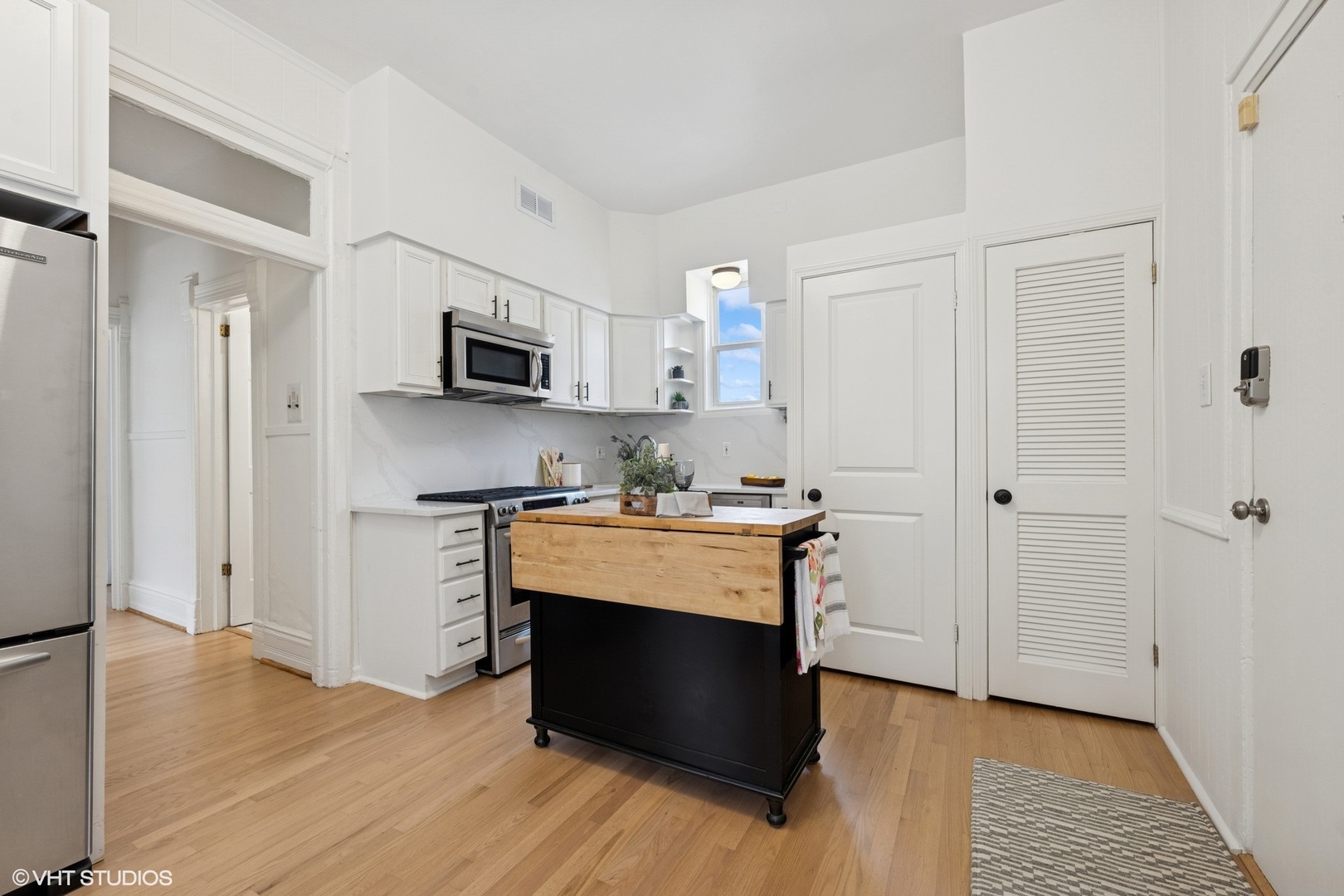 1411 North Wells Street, Unit 3W Chicago, IL 60610 - Photo 28 of 32 a view of kitchen with stainless steel appliances cabinets and wooden floor