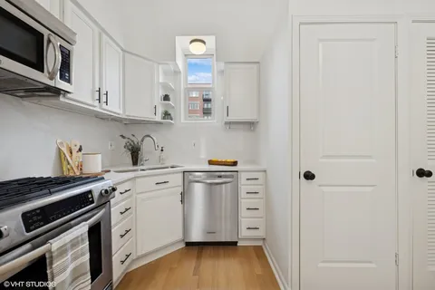 a kitchen with stainless steel appliances white cabinets and a stove