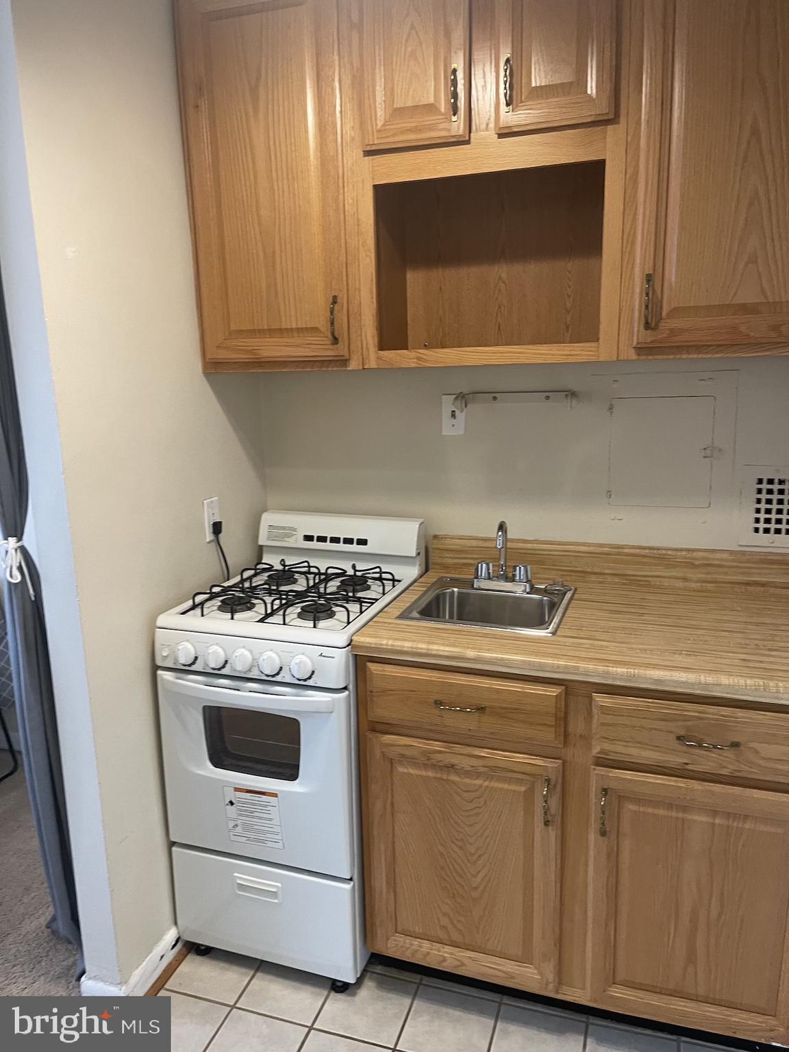 950 25th Street Northwest, Unit 313N Washington, DC 20037 - Photo 12 of 27 a kitchen with a stove microwave and cabinets