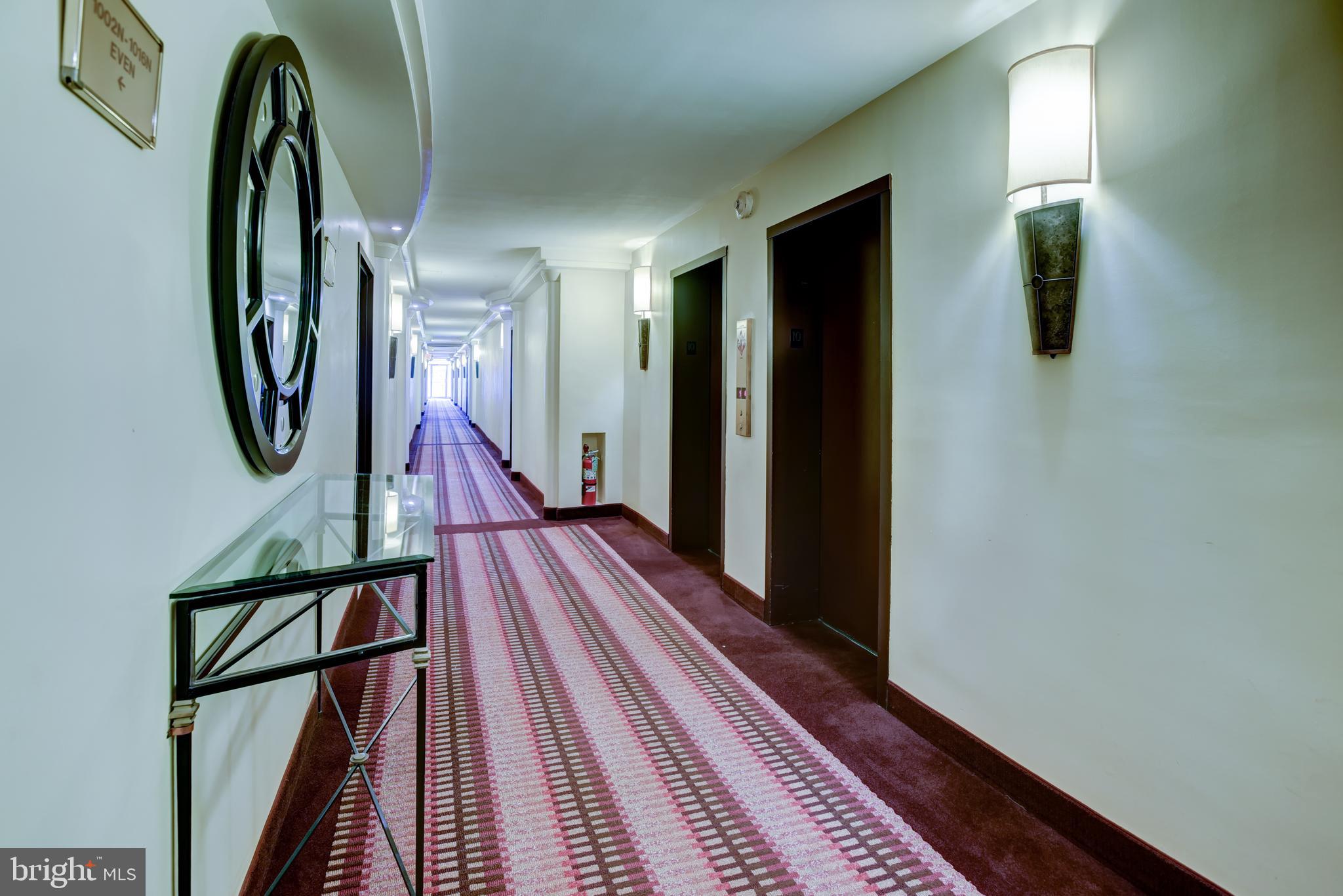 950 25th Street Northwest, Unit 313N Washington, DC 20037 - Photo 5 of 27 a view of a hallway with wooden floor and stairs