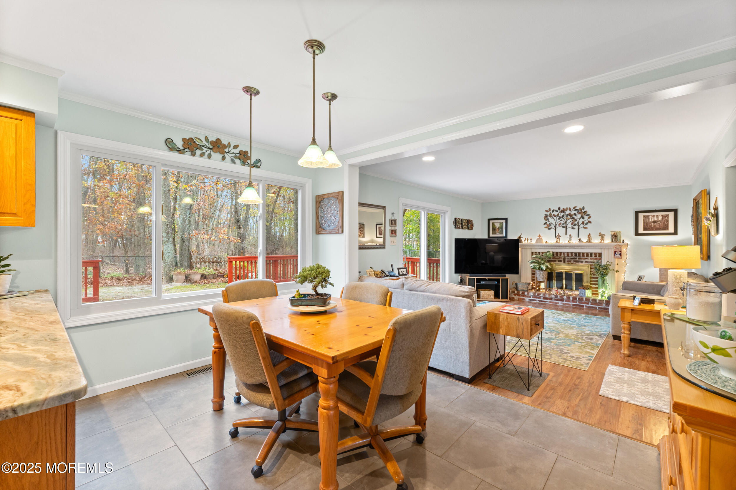 1418 Forest Avenue Brick, NJ 08724 - Photo 15 of 47 a view of a dining room and livingroom with furniture wooden floor a chandelier