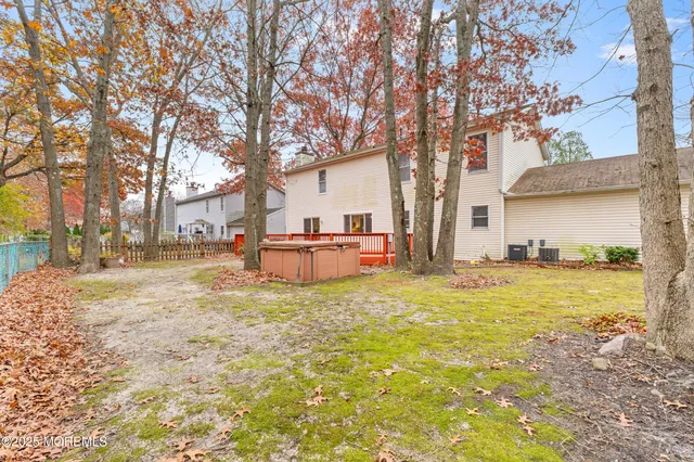 a backyard of a house with table and chairs