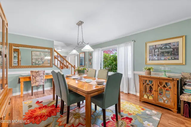 a dining room with furniture and wooden floor