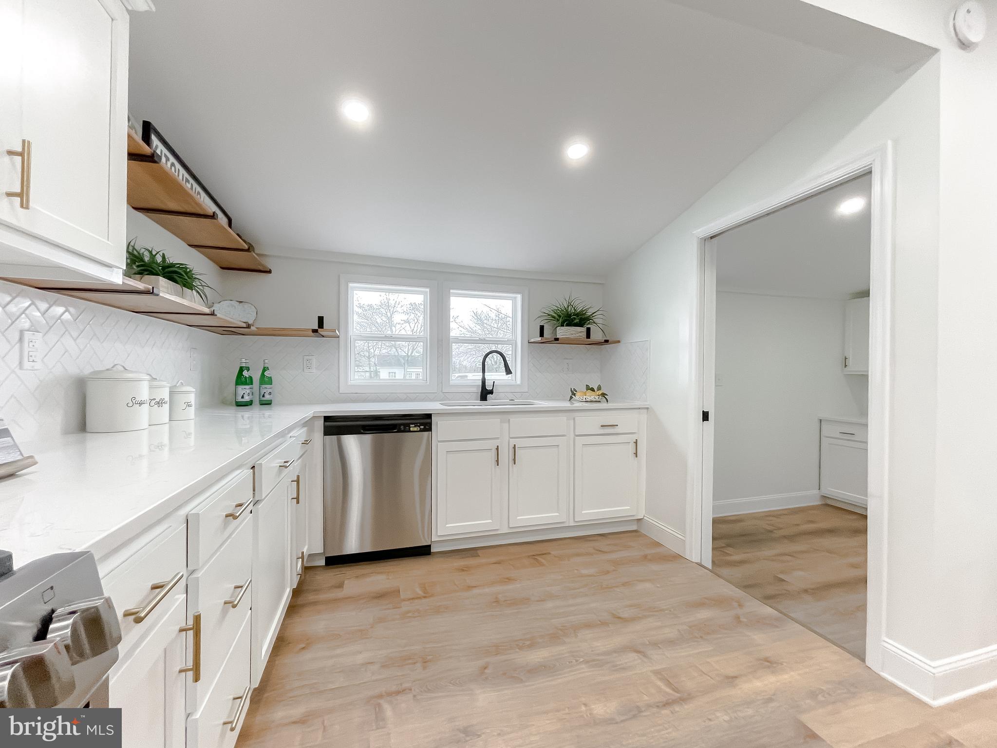 8285 Verne Place Welcome, MD 20693 - Photo 21 of 54 a kitchen with white cabinets and white appliances