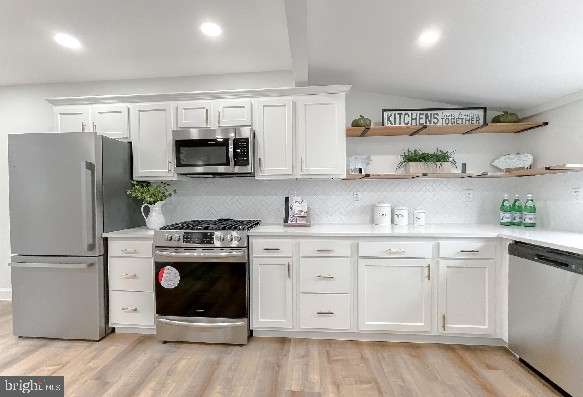 8285 Verne Place Welcome, MD 20693 - Photo 23 of 54 a kitchen with stainless steel appliances granite countertop a refrigerator a stove a sink and white cabinets