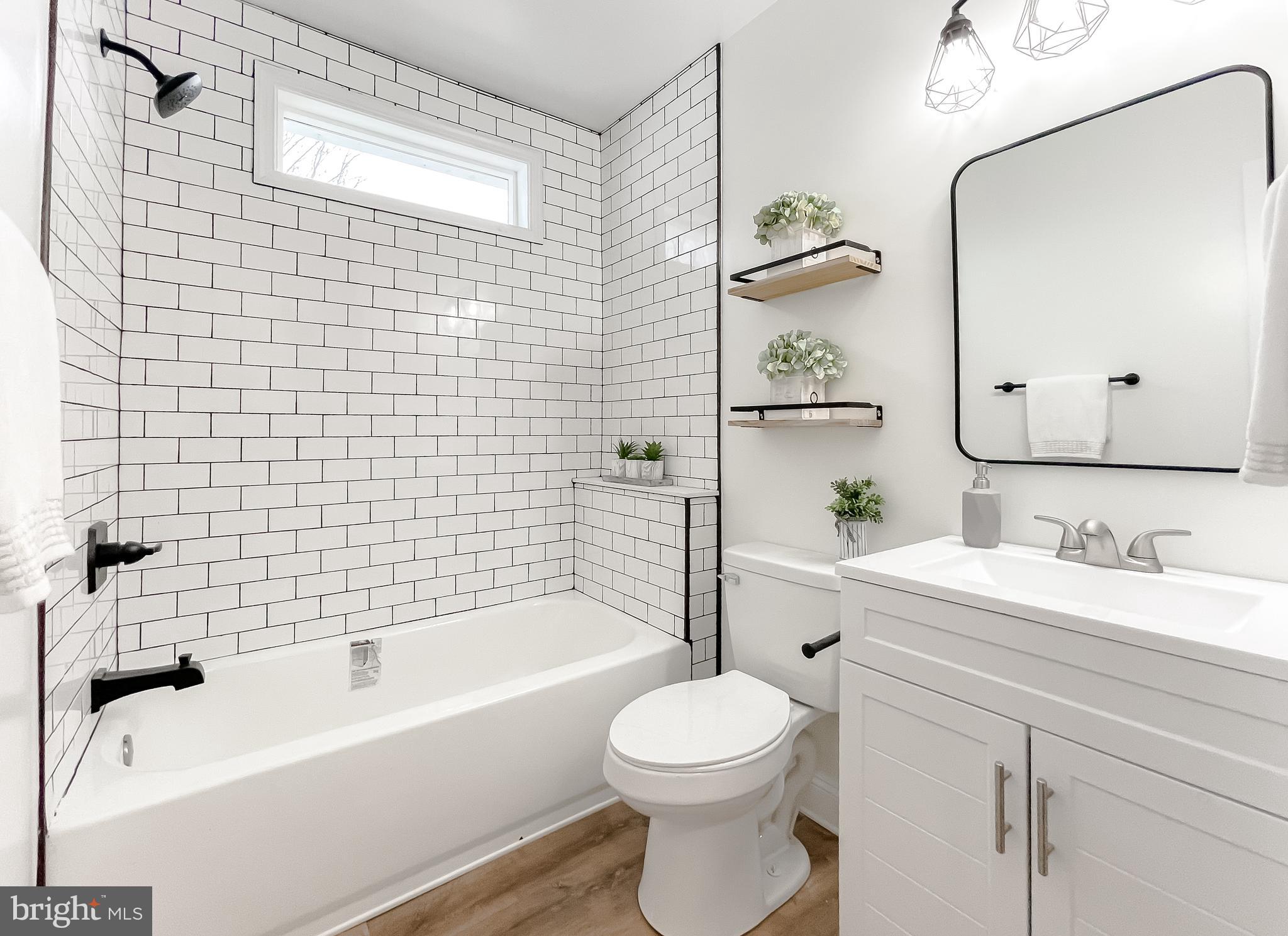 8285 Verne Place Welcome, MD 20693 - Photo 29 of 54 a bathroom with a bathtub shower sink mirror vanity and toilet