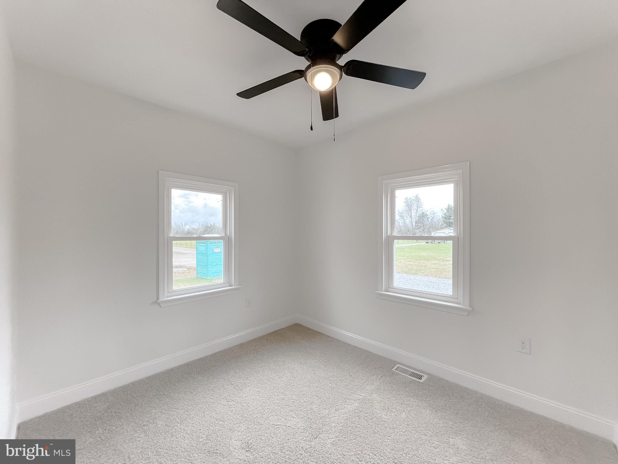 8285 Verne Place Welcome, MD 20693 - Photo 37 of 54 an empty room with a window and a fan